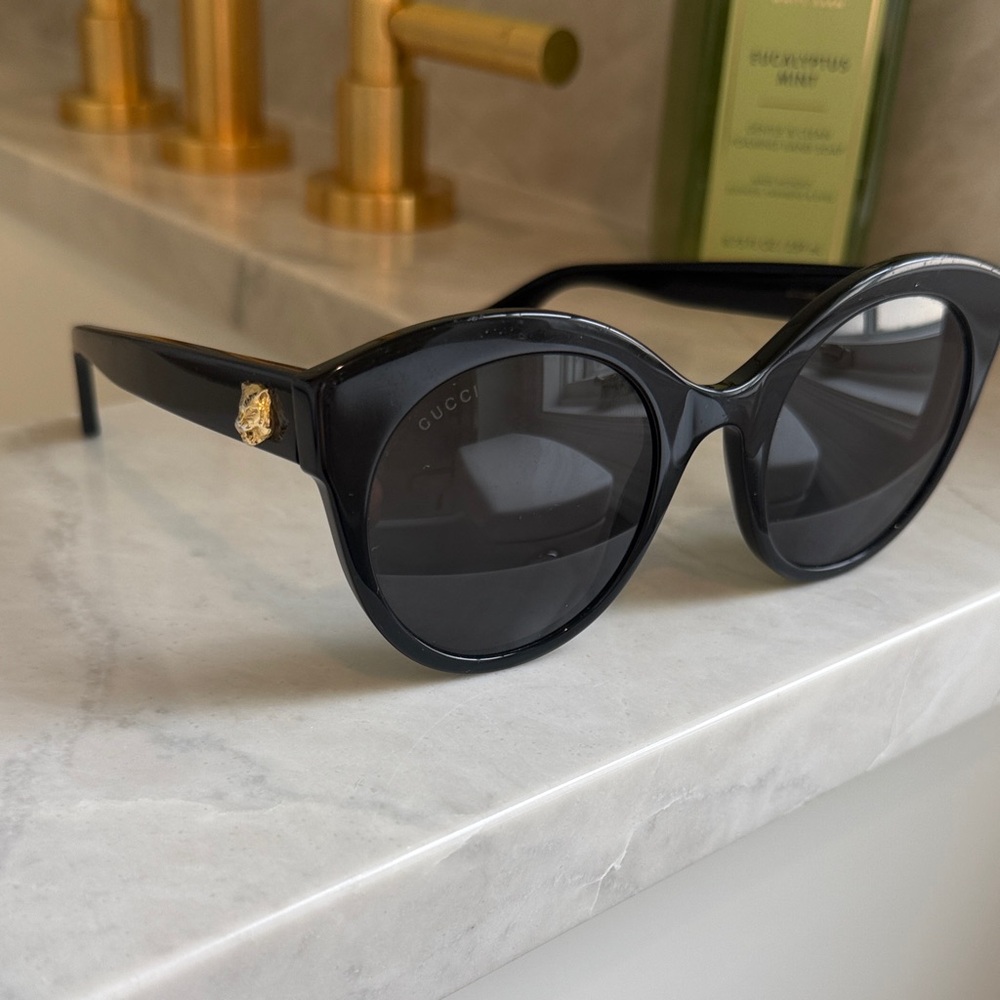 Gucci Black Round Sunglasses with Gold Lion Accent